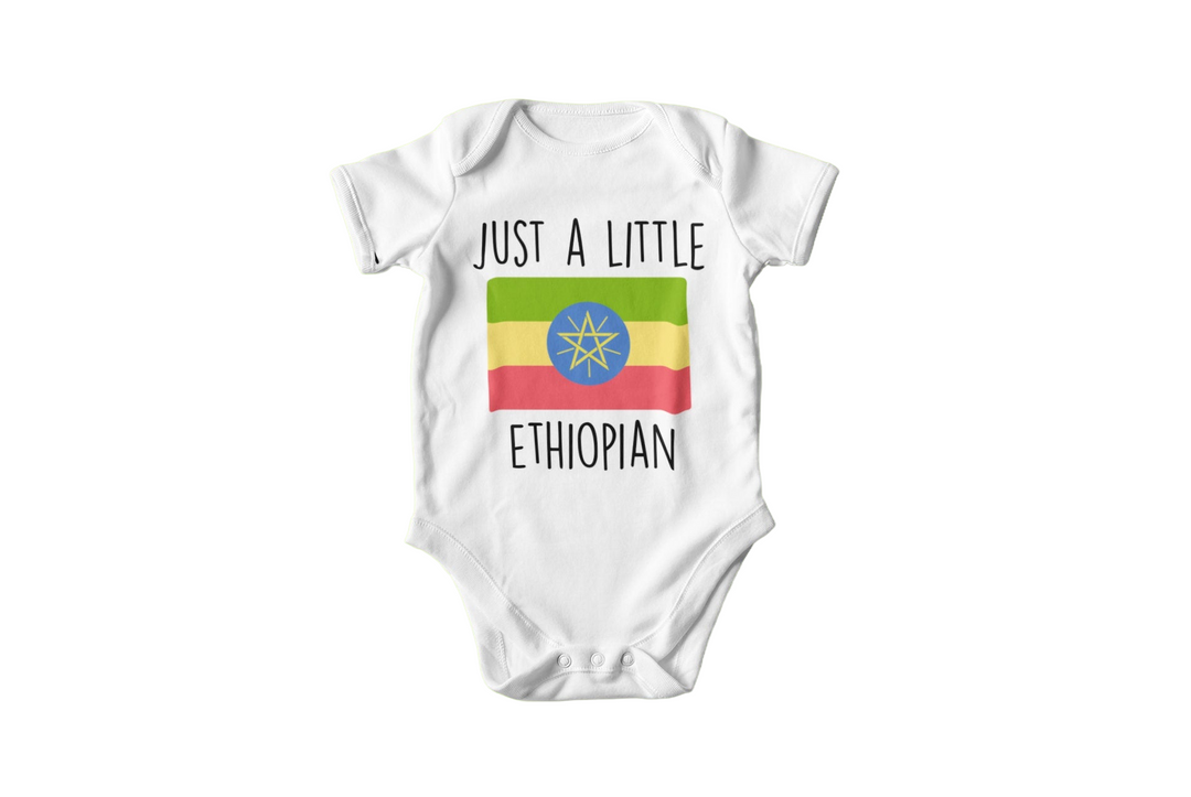 a white bodysuit with the words just a little ethiopian on it