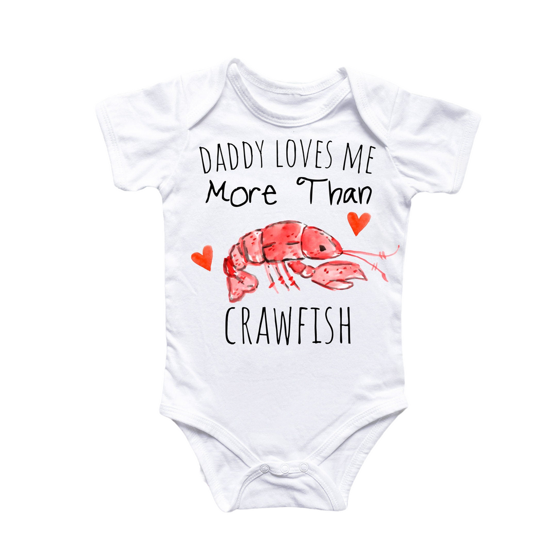 a white bodysuit with the words daddy loves me more than crawfish