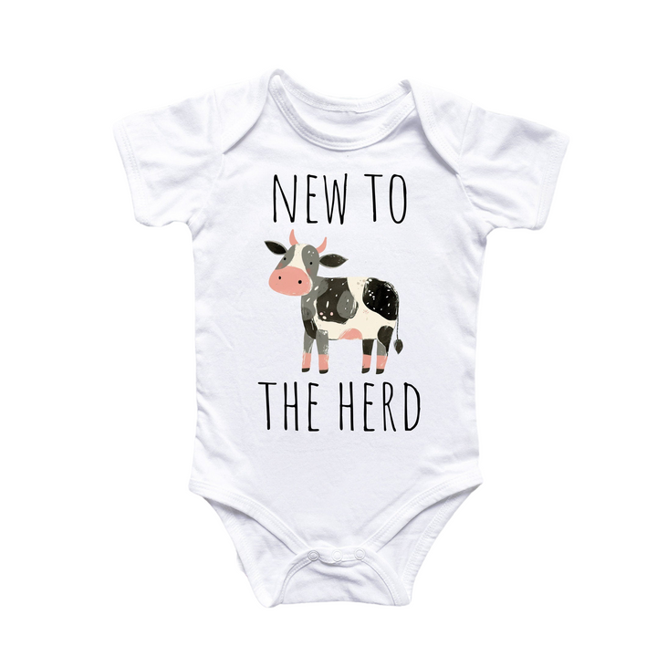 a white bodysuit with a black and white cow that says new to the herd