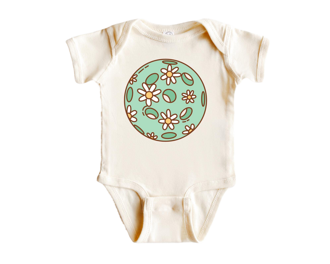 a baby bodysuit with a flowered design on it