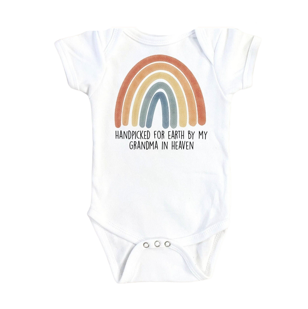 a white bodysuit with a rainbow on it