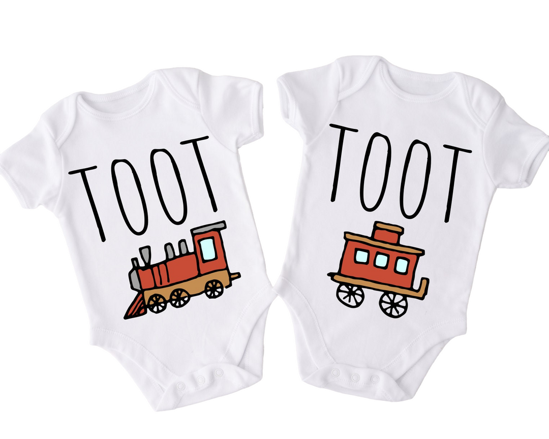 two baby onesuits with a train on them