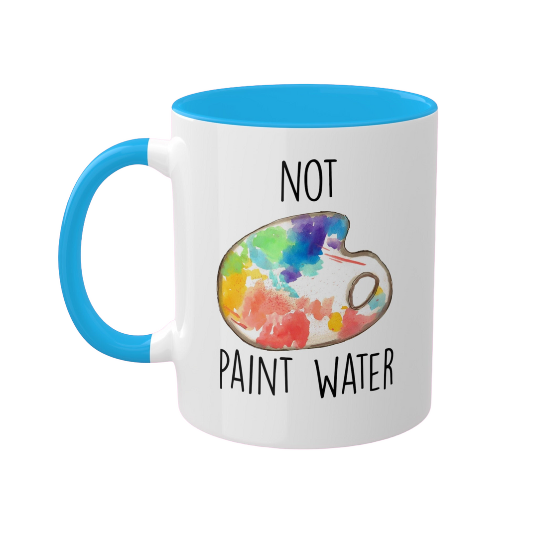 a blue and white coffee mug with a picture of a paint palette on it