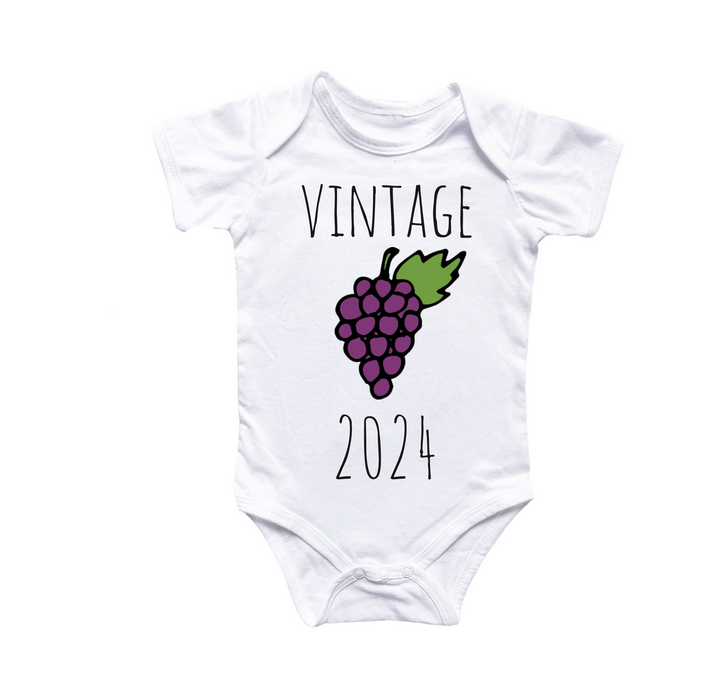 a baby onesuit with a bunch of grapes on it