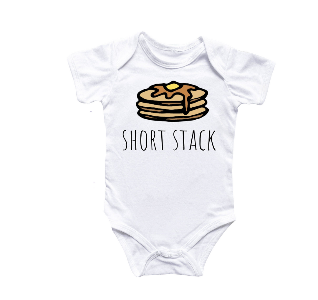 a white onesuit with a stack of pancakes on it