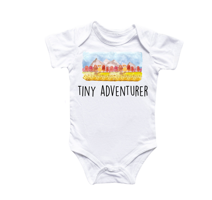 a white bodysuit with a picture of tiny adventurer on it