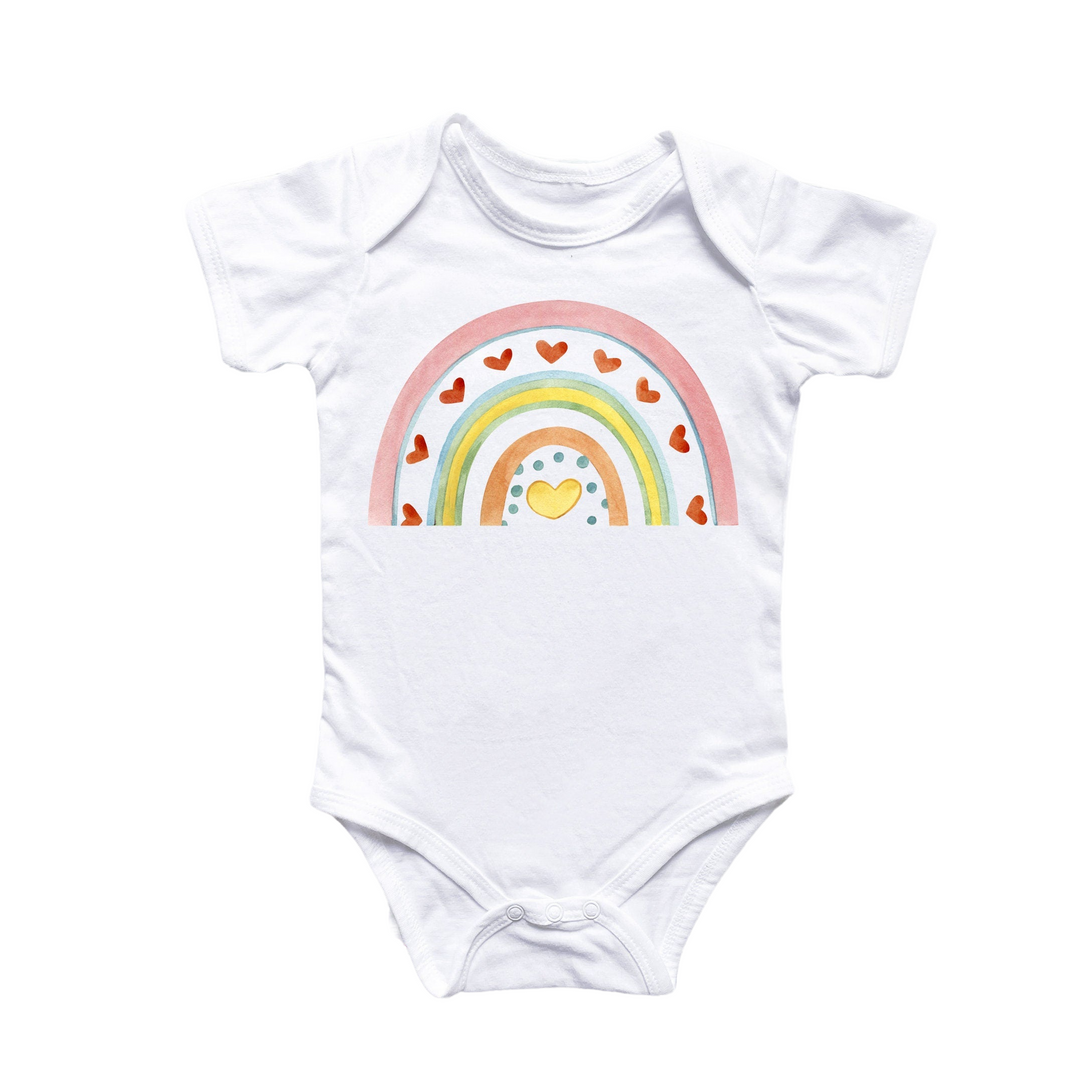 a white bodysuit with a rainbow and hearts on it