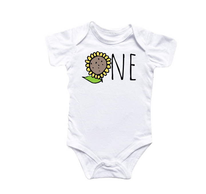 a white onesie with a sunflower on it