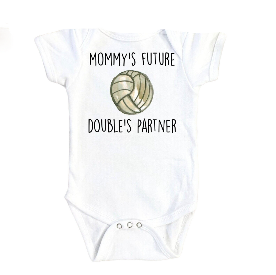 a white baby bodysuit with a volleyball ball on it