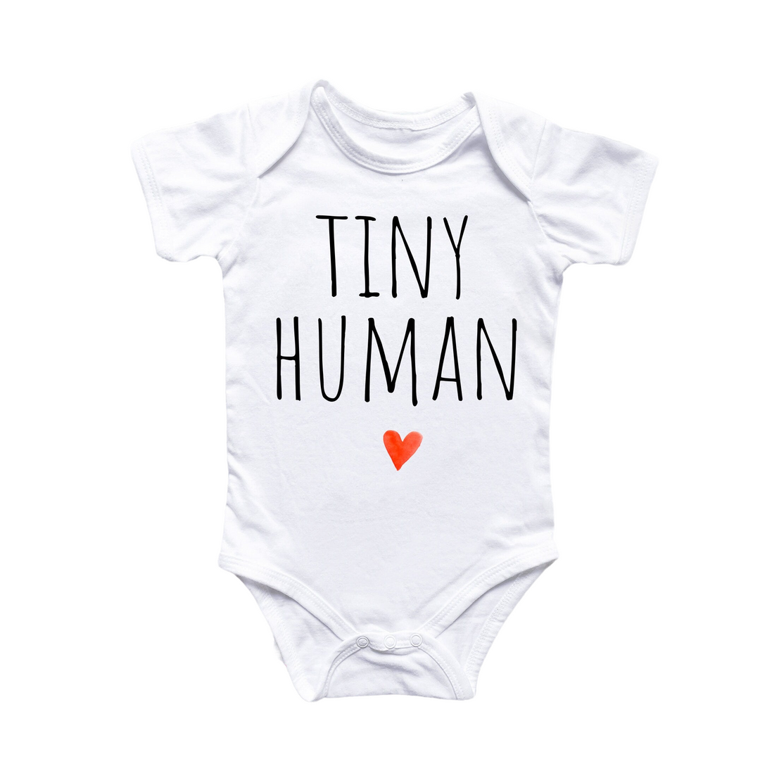 a white bodysuit with tiny human written on it