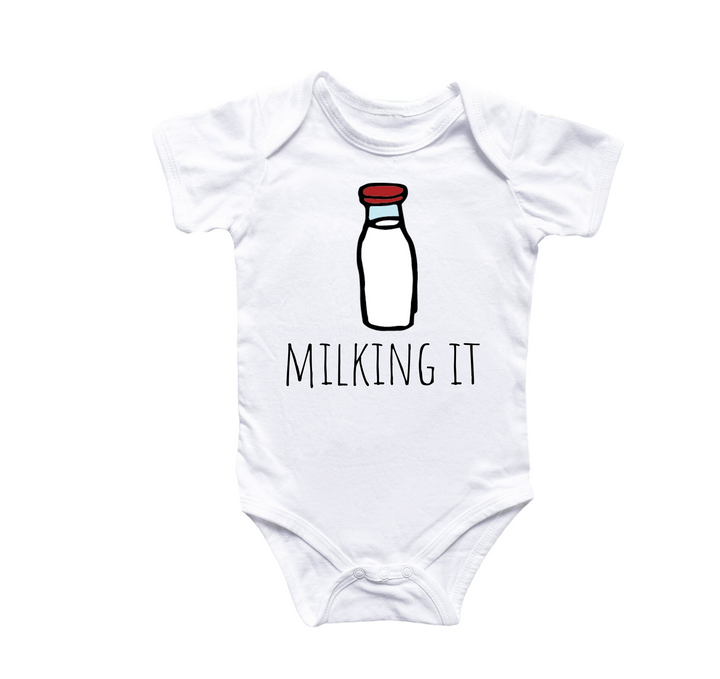 a white bodysuit with a picture of a bottle of milk that says milking