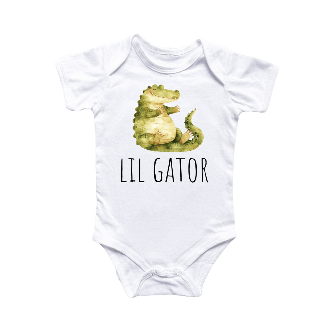 a white bodysuit with a green alligator on it