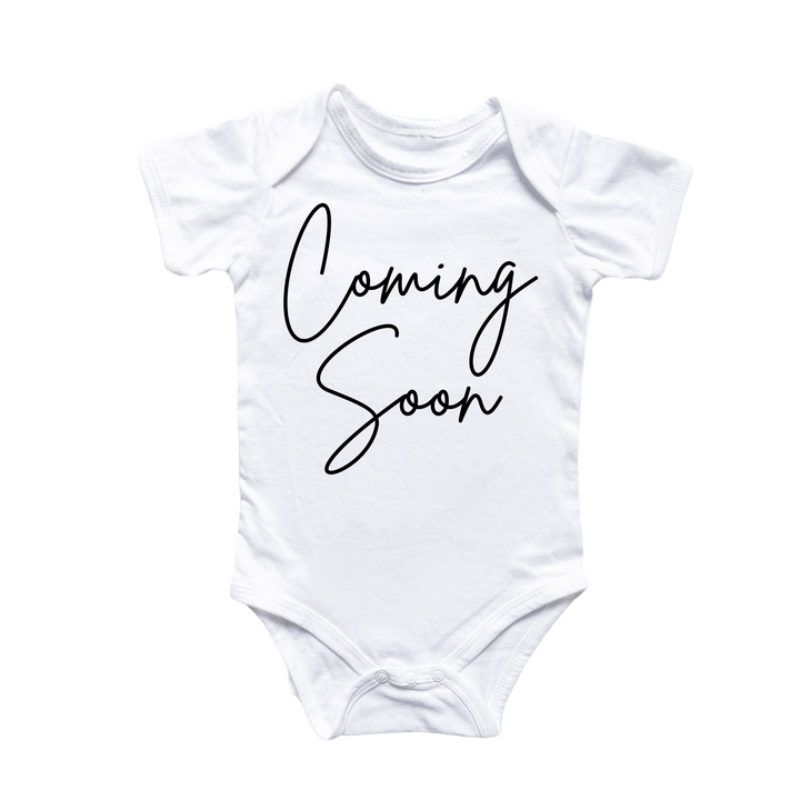 a white onesuit with the words coming soon printed on it