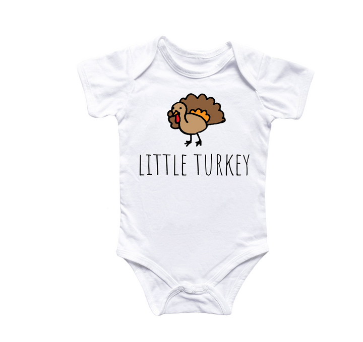 a white baby bodysuit with a turkey on it