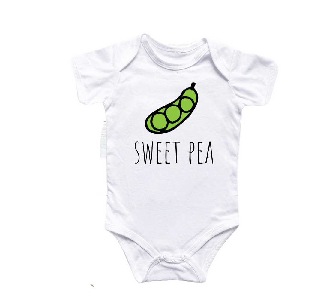 a white bodysuit with a green pea on it