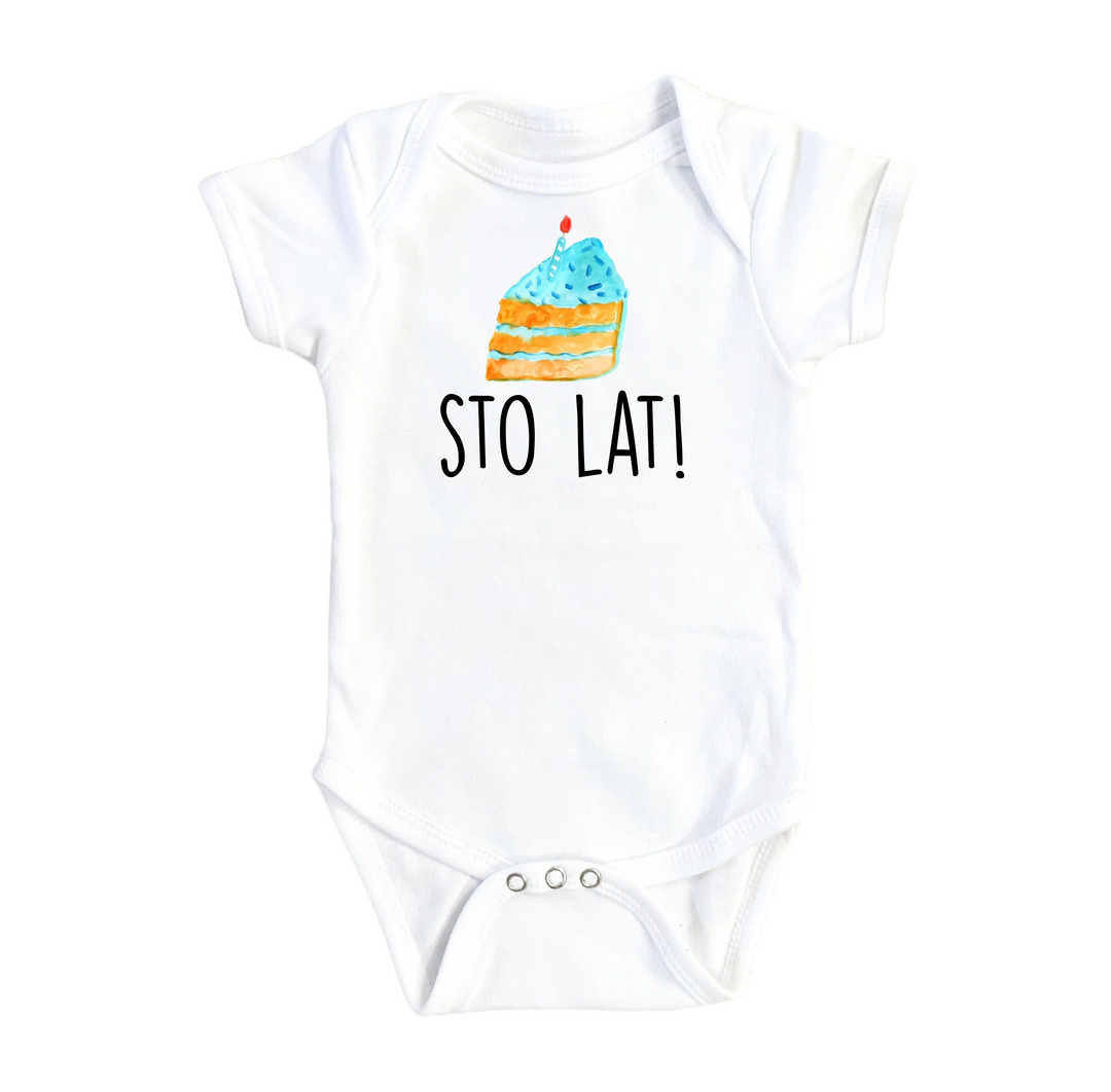 a white baby bodysuit with a cake on it