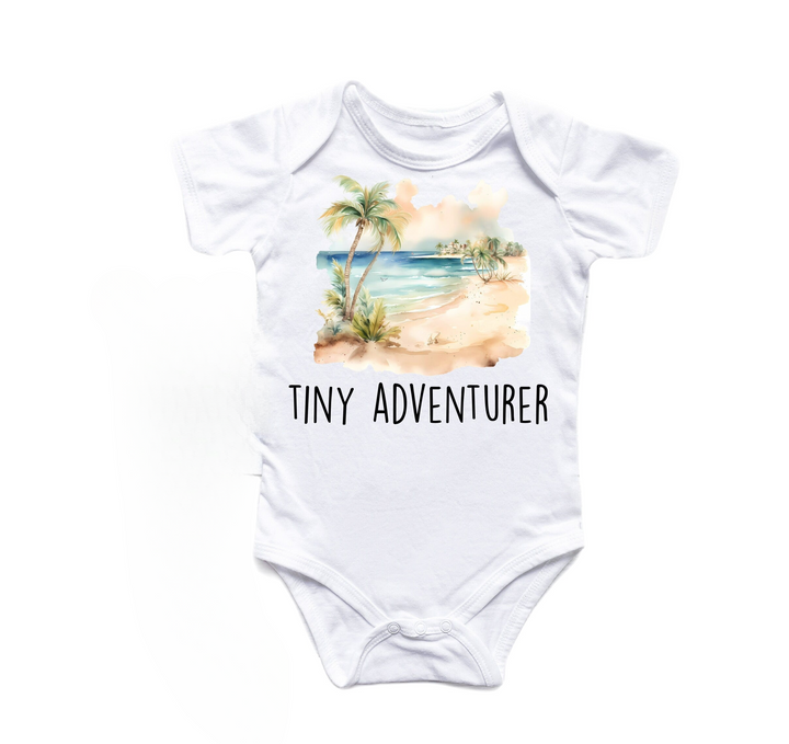 a white onesuit with the words tiny adventurer printed on it