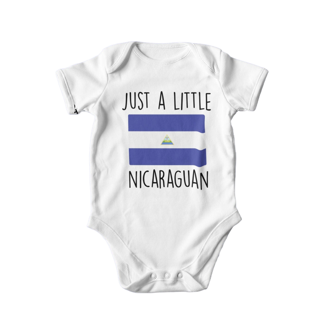 a baby bodysuit with the words just a little nicaraguan on it