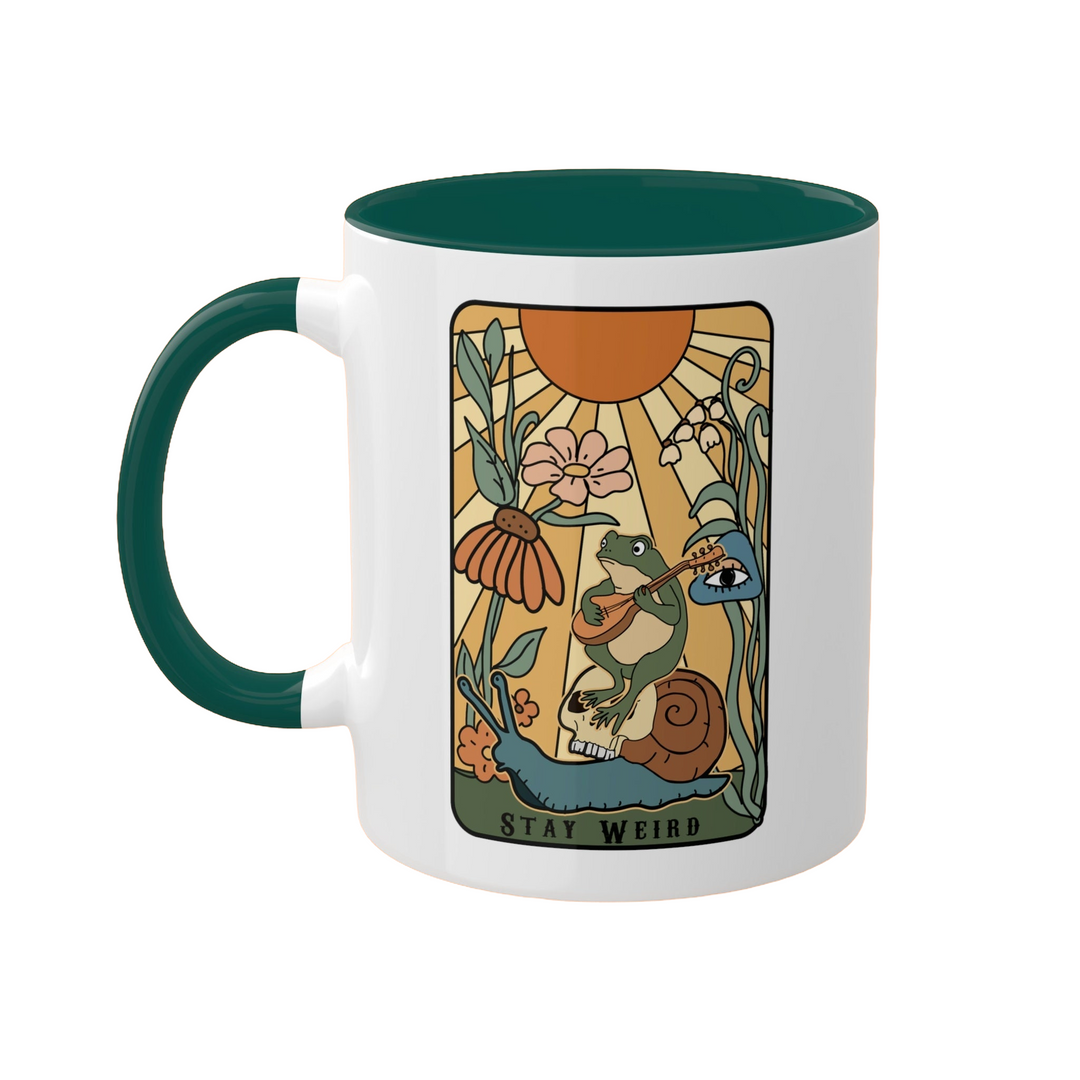 a green and white coffee mug with a picture of a mermaid