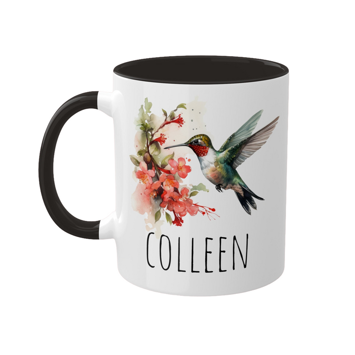 a white and black coffee mug with a hummingbird on it