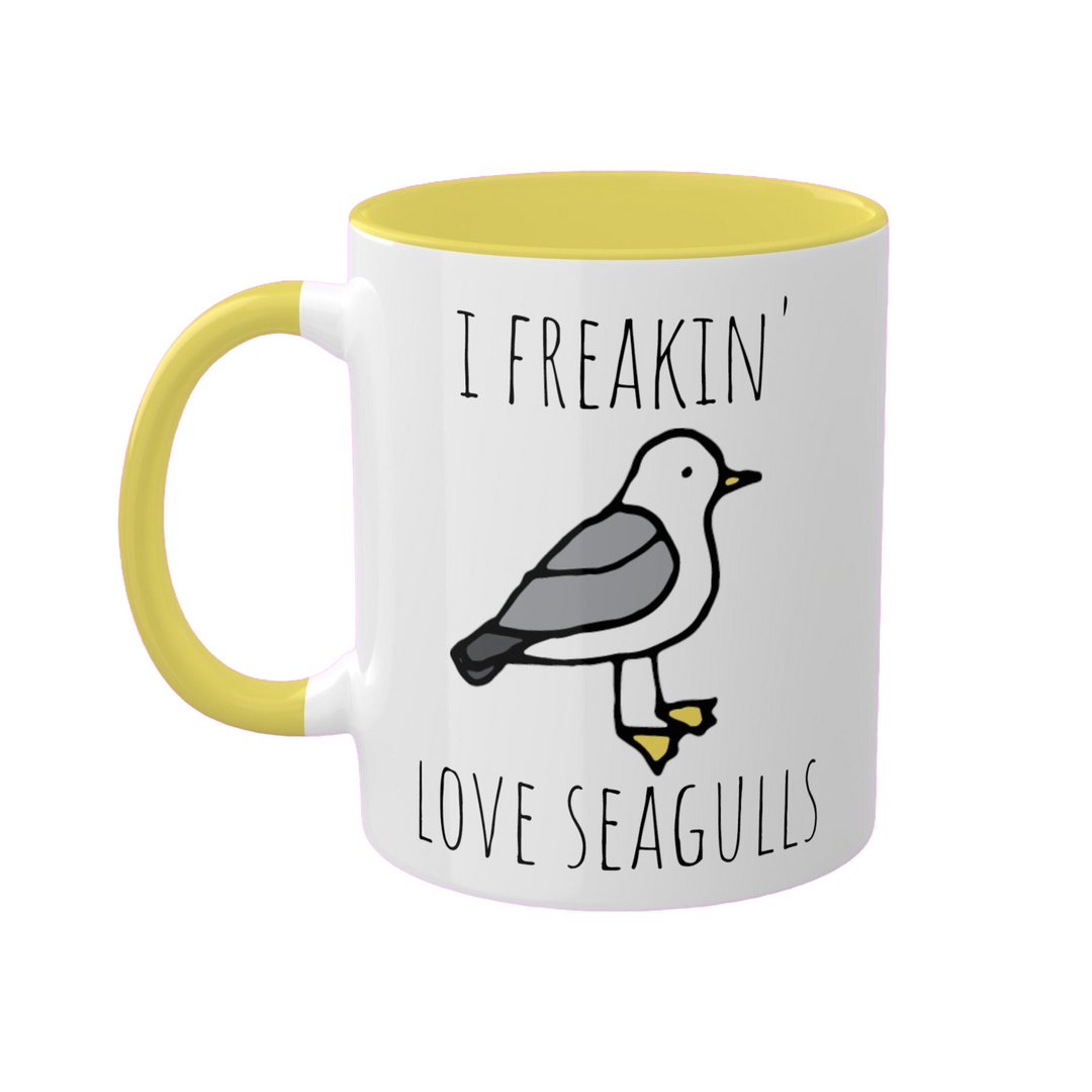 a yellow and white coffee mug with a bird on it