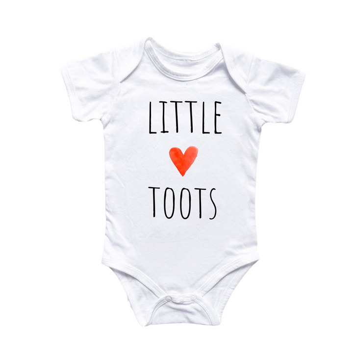 a white bodysuit with a red heart that says little toots