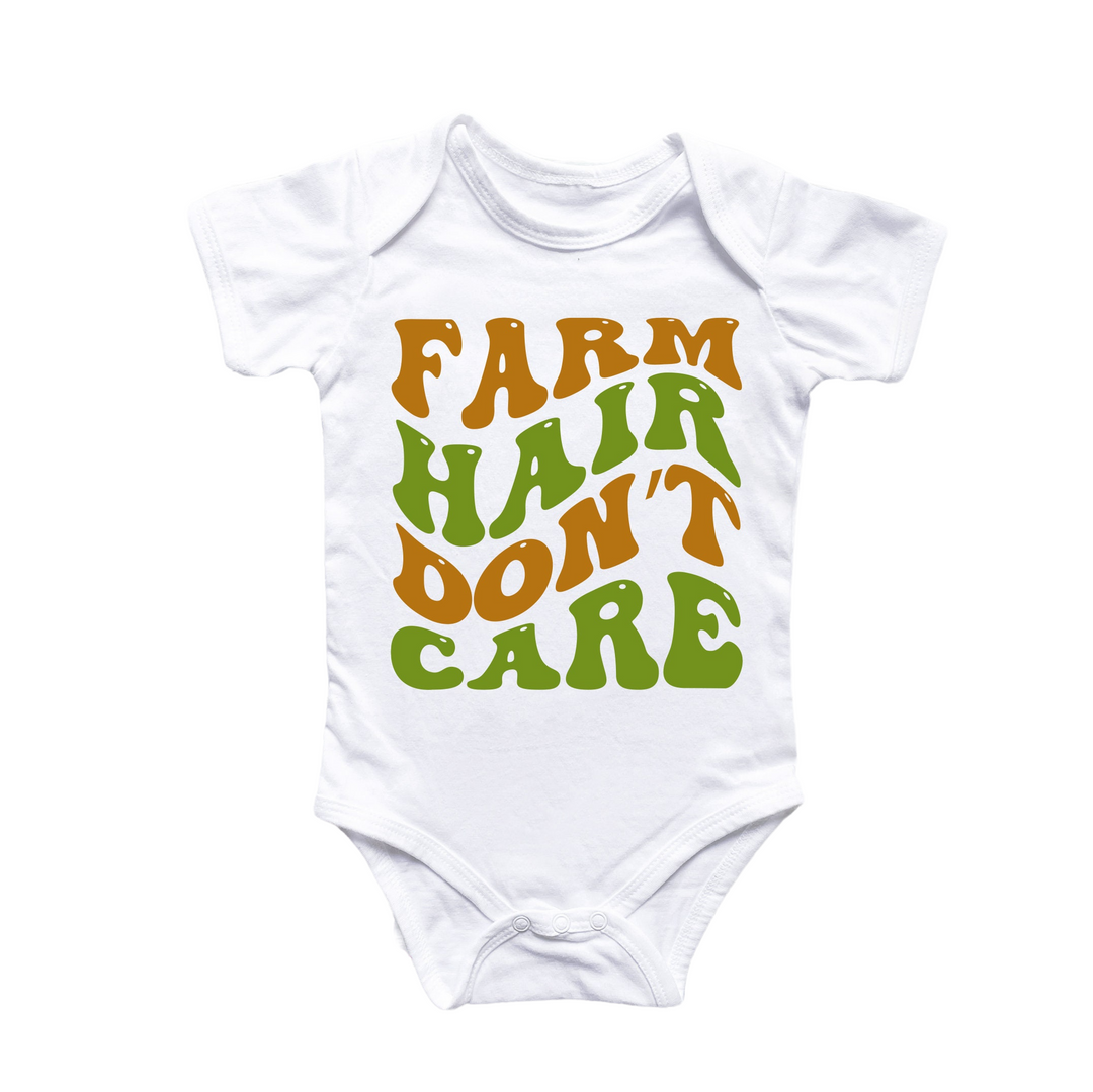 a white bodysuit with the words farm hair don't care printed on it