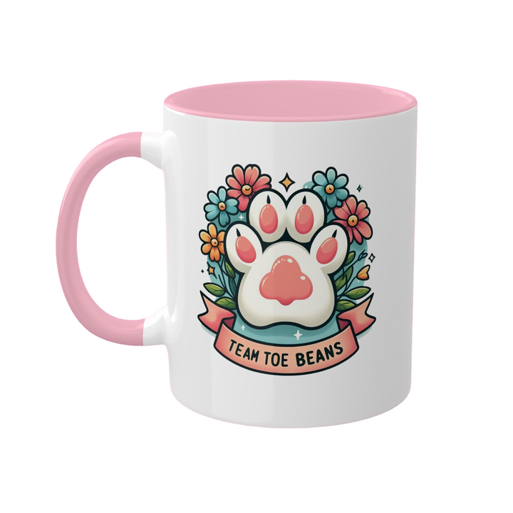 a pink and white coffee mug with a paw on it