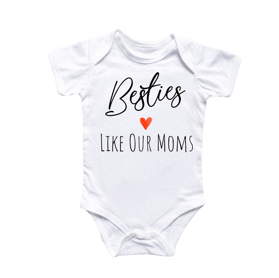 a white onesuit with the words besties like our moms on it