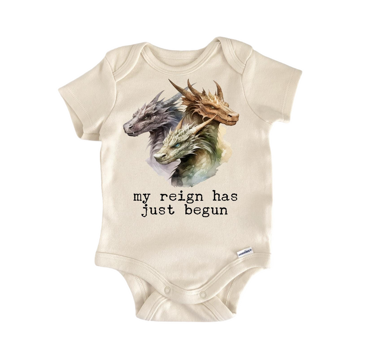 a baby bodysuit with a picture of a dragon on it