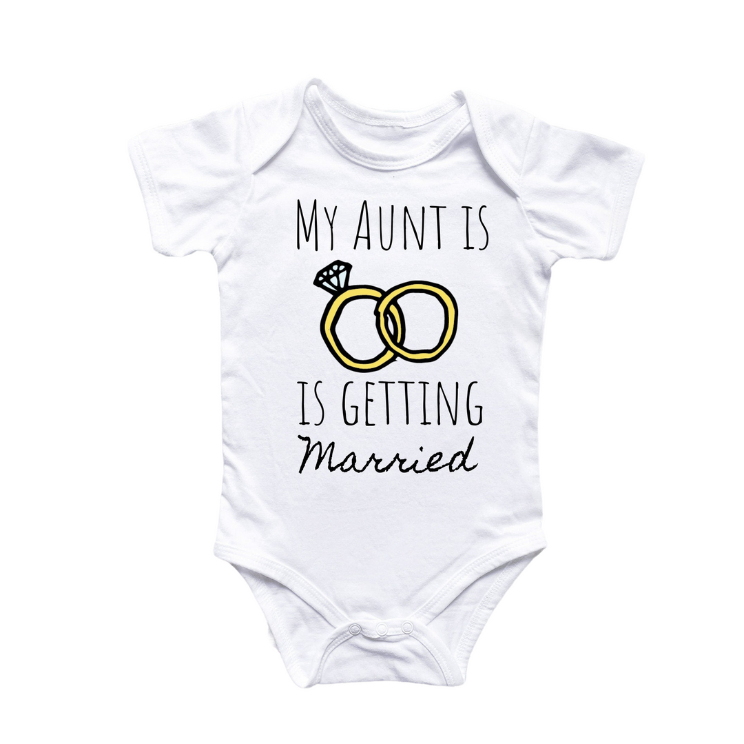 a baby bodysuit with a picture of two wedding rings on it