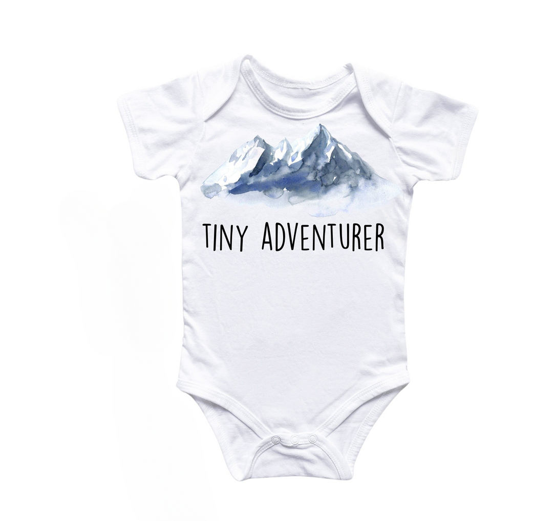 a white bodysuit with a picture of a mountain on it