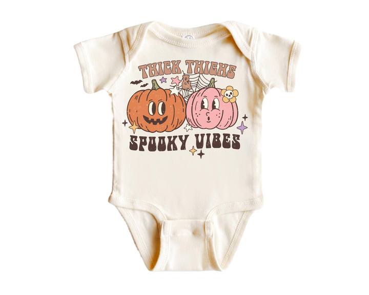 a baby bodysuit with two pumpkins on it