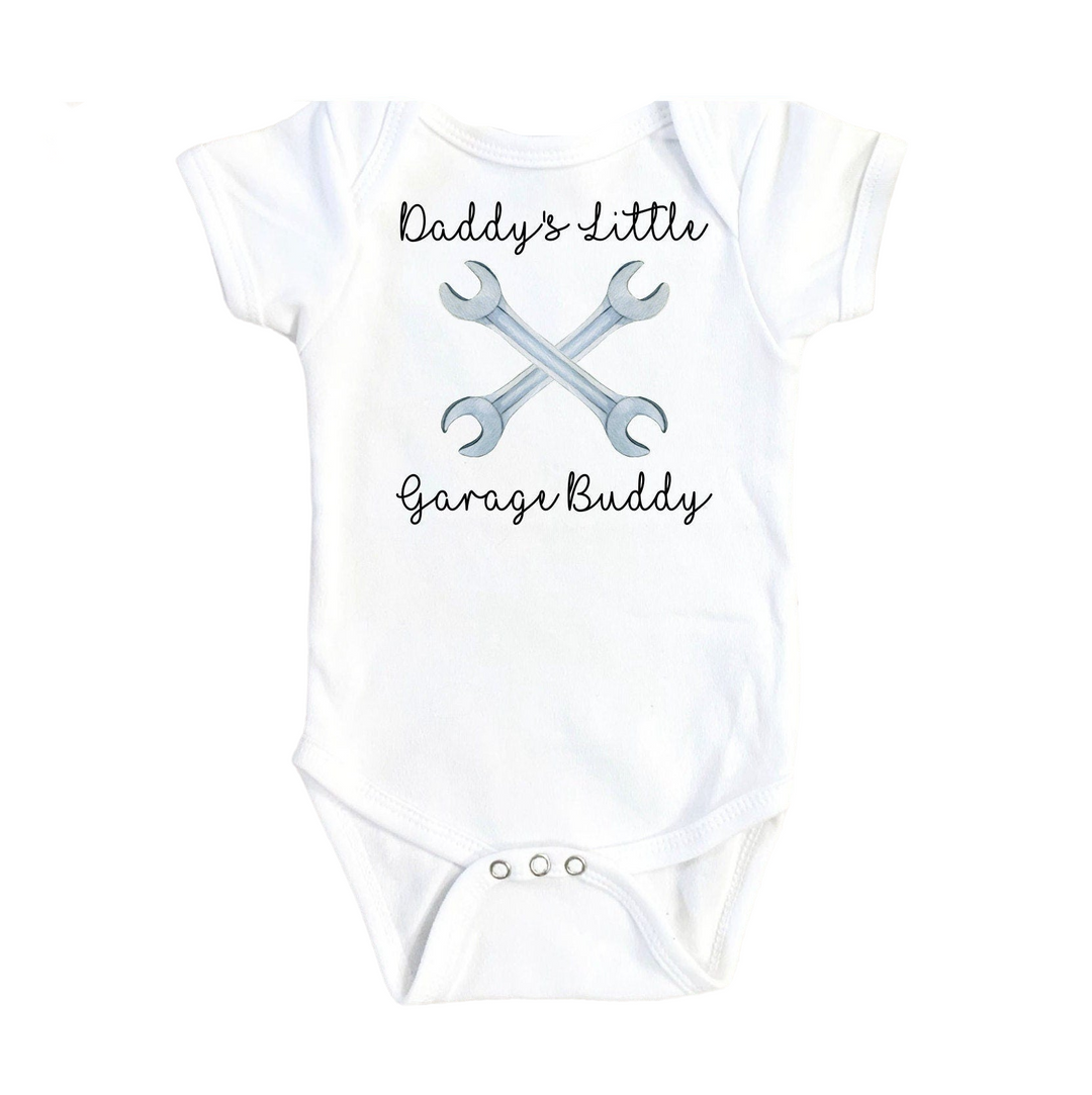 a baby bodysuit with a wrench and a wrench on it