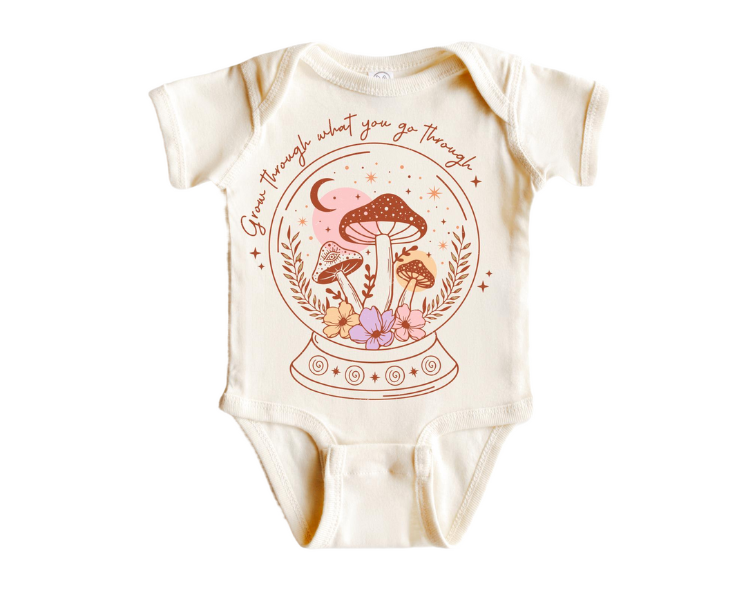 a baby bodysuit with a picture of a mushroom on it