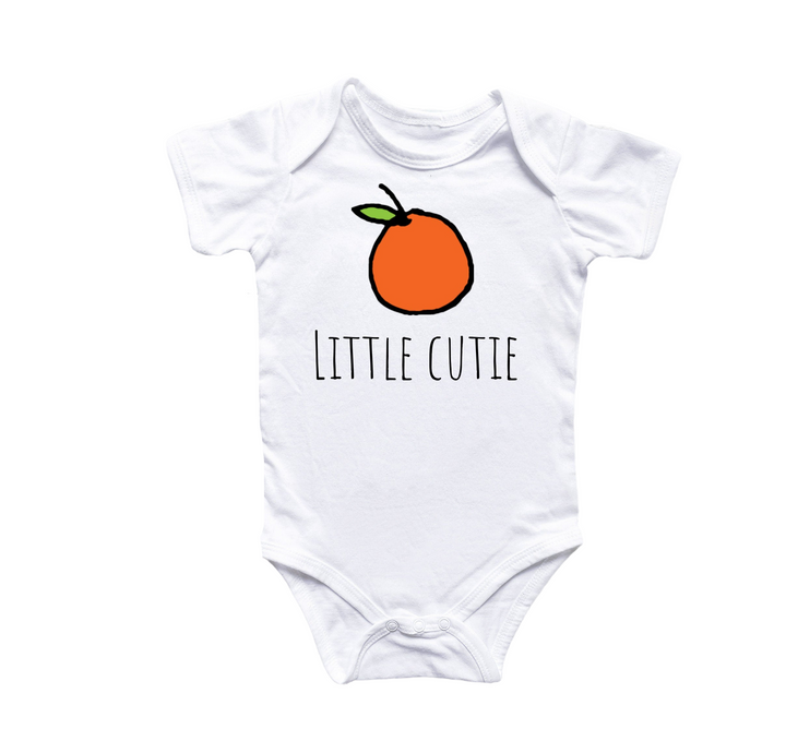 a white baby bodysuit with an orange on it