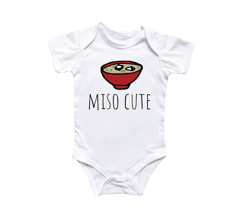 a baby bodysuit with a bowl of food on it