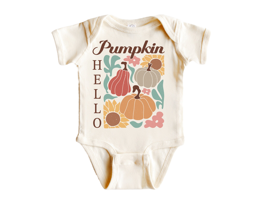 a baby bodysuit with pumpkins and leaves on it