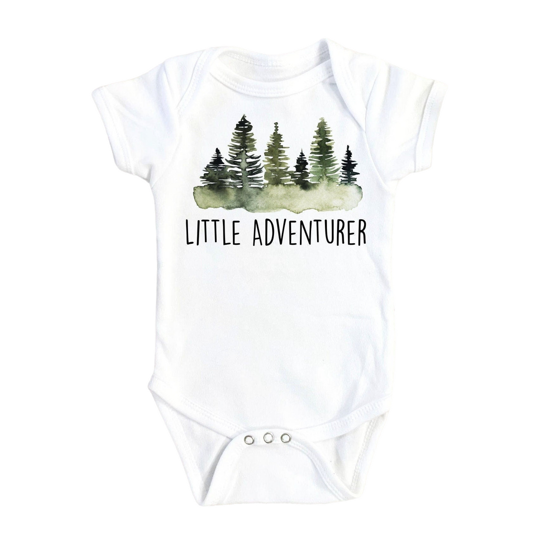 a white bodysuit with trees and the words little adventurer on it