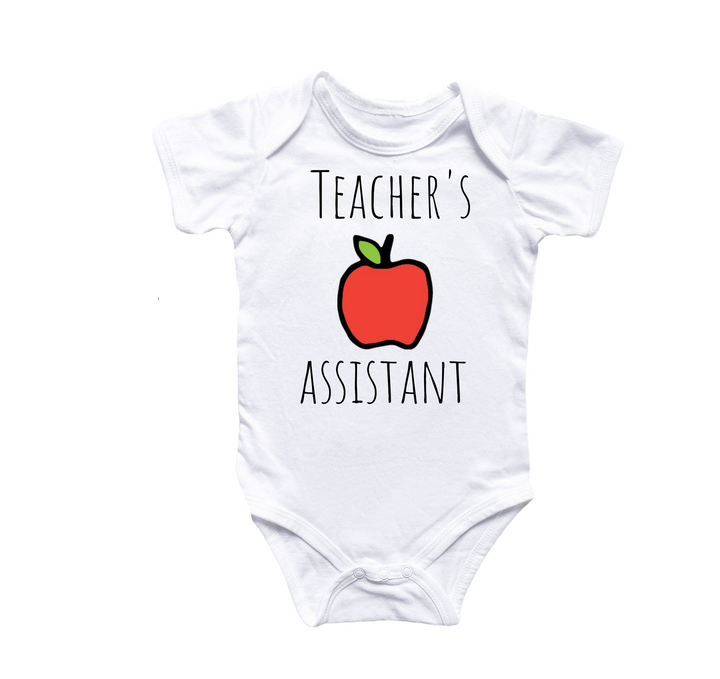 a white bodysuit with a red apple on it that says teacher's assistant