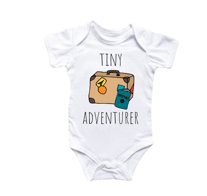 a white bodysuit with a picture of a suitcase that says tiny adventurer