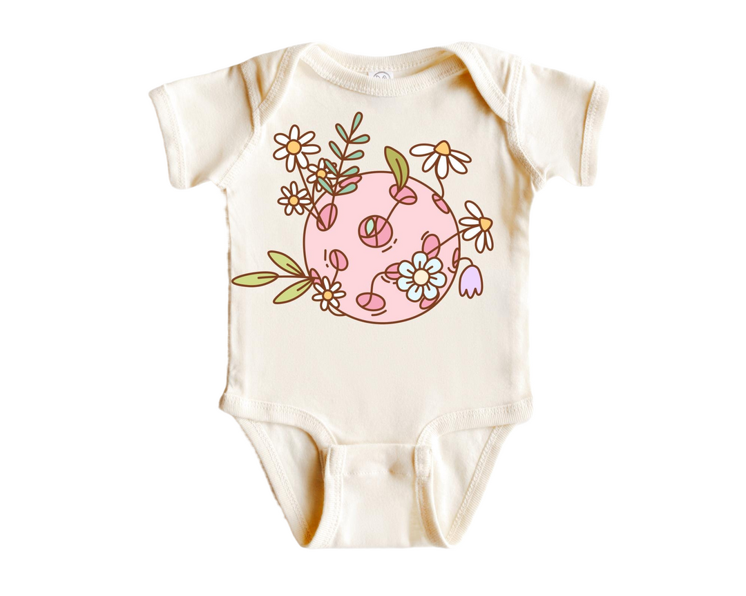 a baby bodysuit with flowers and leaves on it