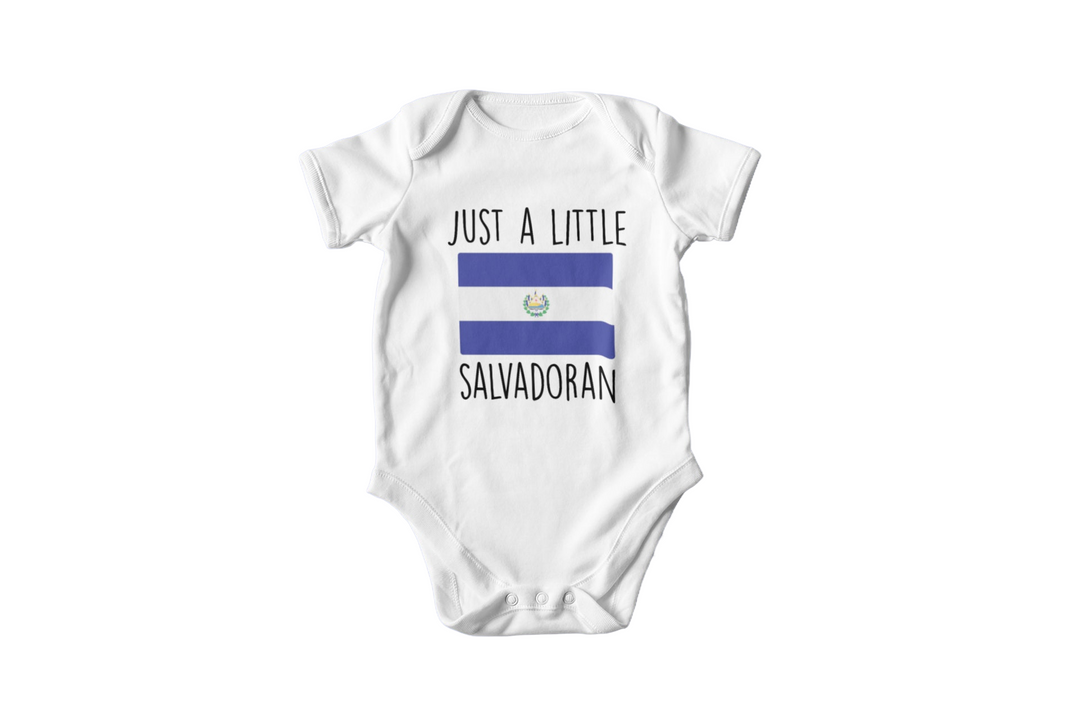 a baby bodysuit with the words just a little in blue and white