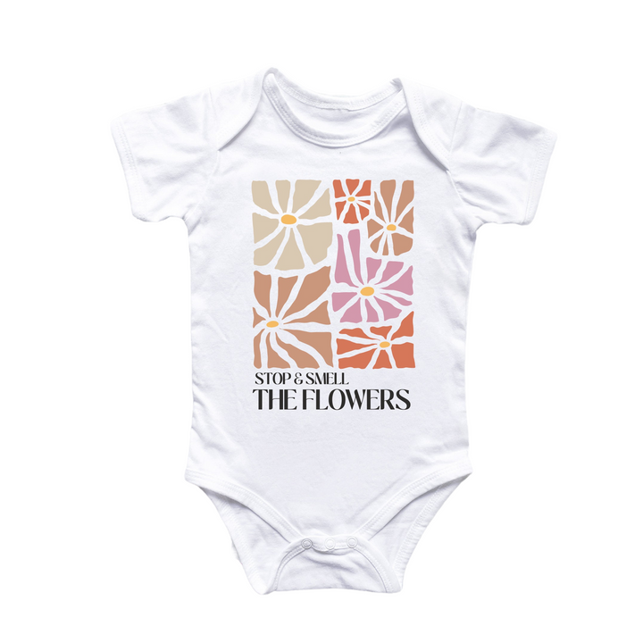 a white bodysuit with a flower design on it