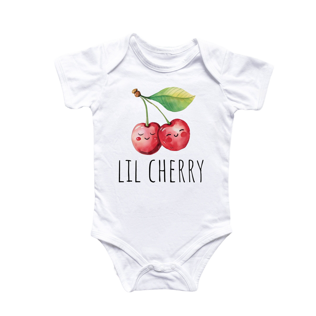 a white bodysuit with two cherries on it