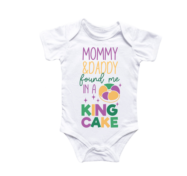 a white bodysuit with the words mommy and daddy found me in a king cake