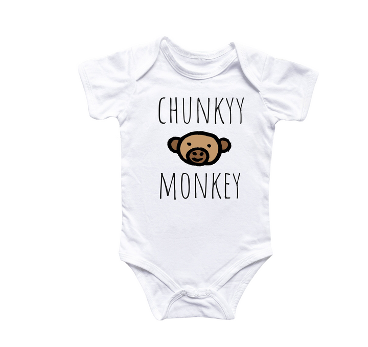 a white baby bodysuit with a brown monkey on it