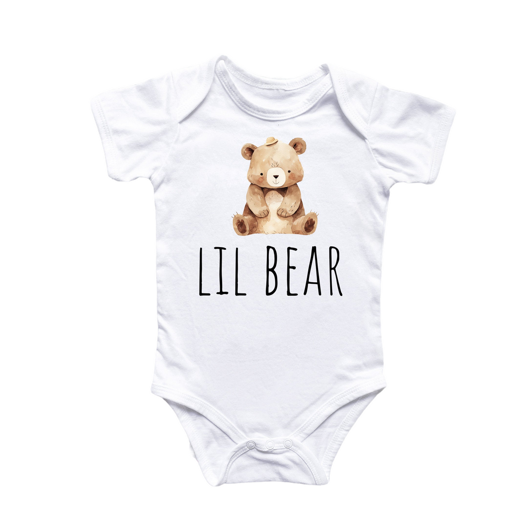 a white bodysuit with a brown teddy bear on it