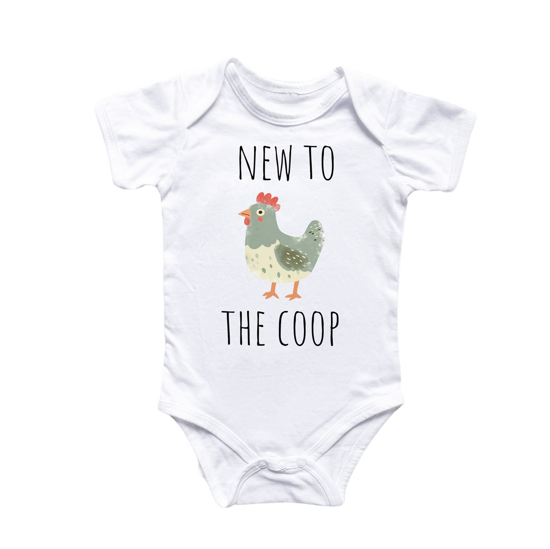 a white baby bodysuit with a chicken on it