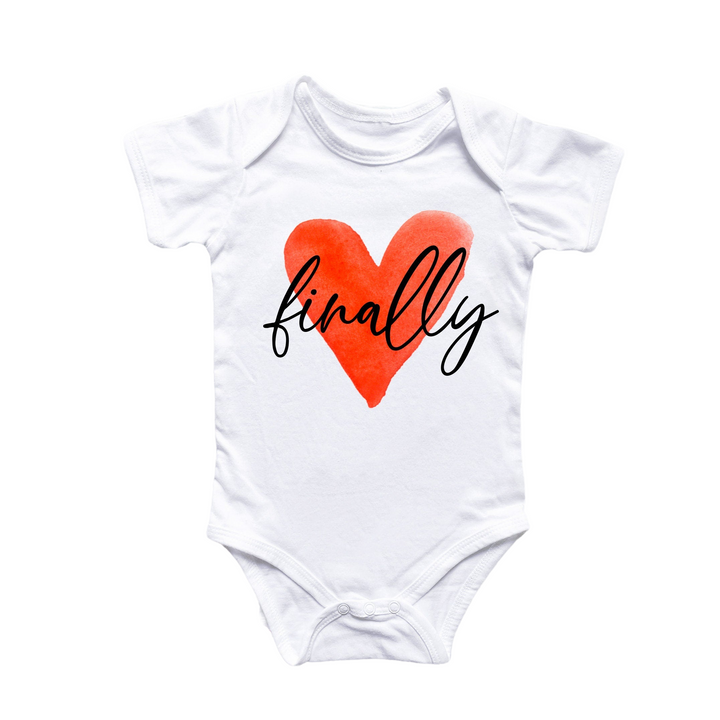 a white baby bodysuit with a red heart that says finally